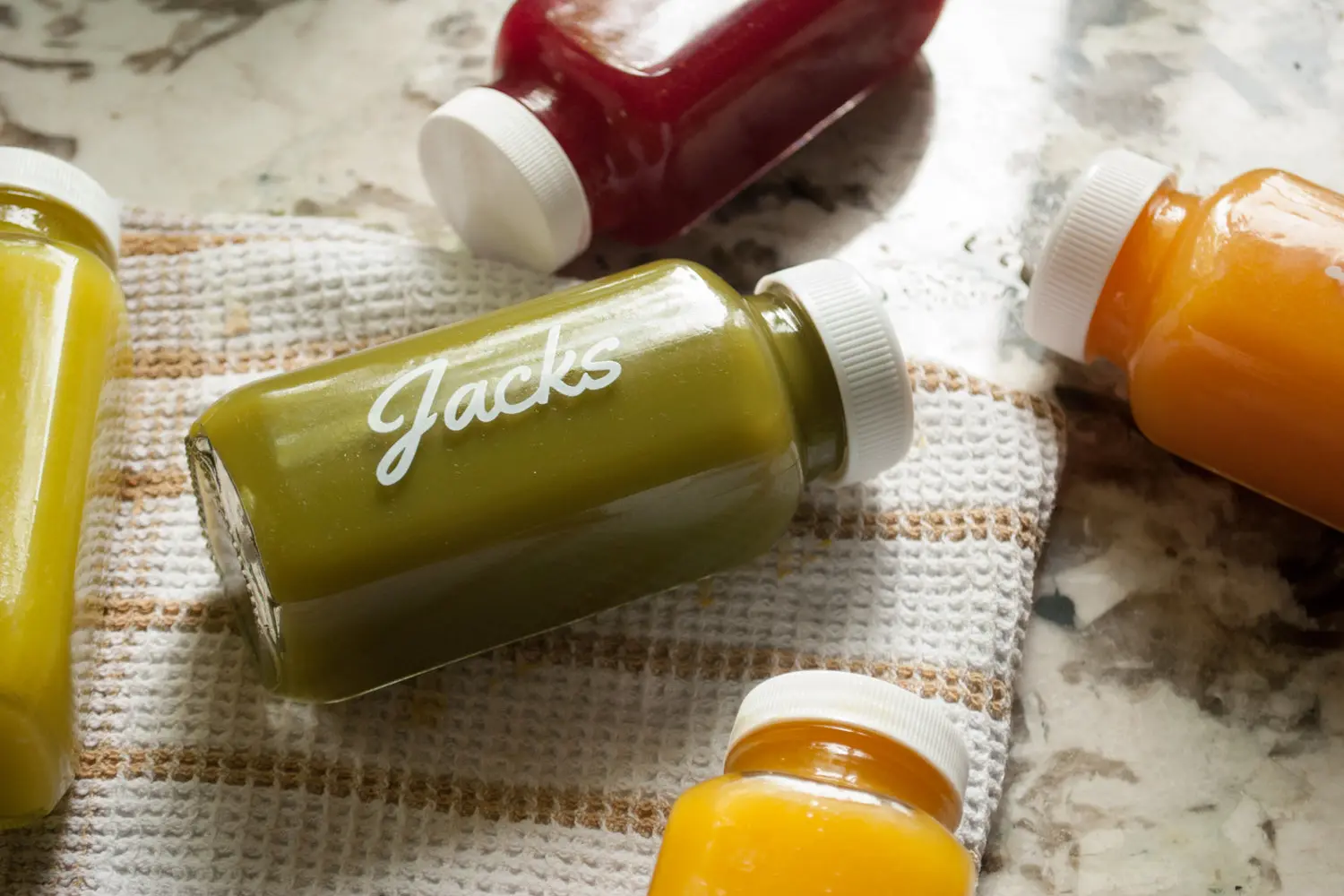 Assorted Farmer Jack’s cold-pressed juice bottles